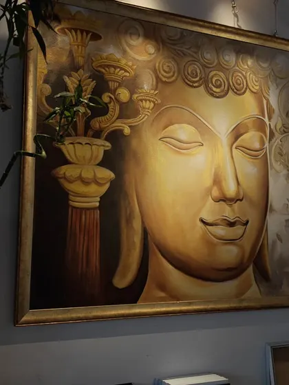 A large, golden Buddha painting can bring a sense of peace and grandeur to any space. This piece, with its serene expression and warm tones, is a favorite among our collectors for creating a meditative environment.
