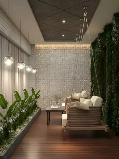 This long balcony is transformed into a tranquil retreat with a full-length vertical garden on one side and a planter bed on the other. A wooden swing provides a cozy spot for relaxation, while pendant lights add a warm glow, making the space usable day and night.