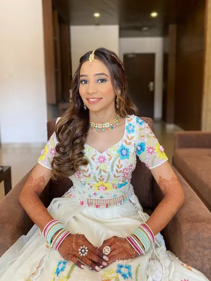 The complete look for Gunjan. Her colorful outfit, fresh makeup, and beautiful smile create a look that is perfect for the books.