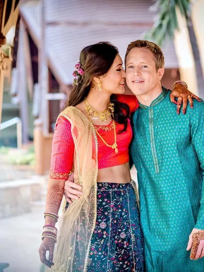 A sweet and intimate portrait. The bride whispers in the groom's ear, a secret moment captured forever.
