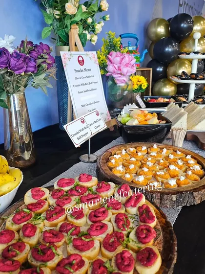 Another shot from a corporate office inauguration, showcasing the elegant setup with balloons and a variety of appetizers like beetroot crostini and cheese corn sandwiches.