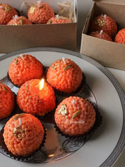 A lit ladoo candle, showing how this fun and unique creation brings a warm glow to any setting.