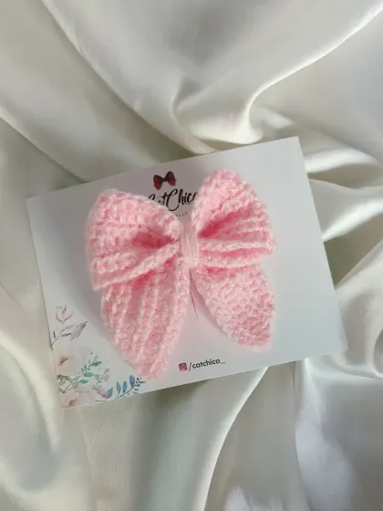 A delicate baby pink sailor bow, perfect for a soft and pretty look.