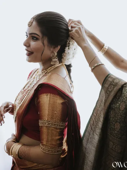 A candid moment of the bride getting her hair done, a beautiful behind-the-scenes shot.