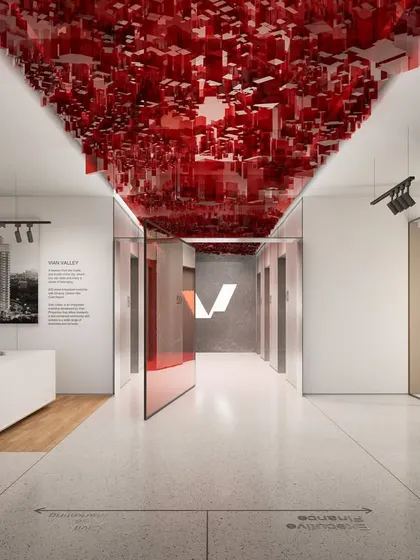A dramatic red sculptural ceiling installation marks a key point in the Vian Office's central corridor. This bold design element injects energy and visual interest, guiding movement while reflecting the client's vision for a dynamic and futuristic workspace.