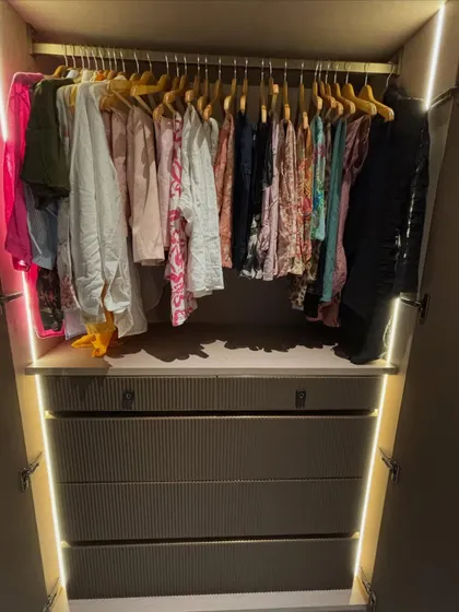 A calm wardrobe starts with a good system. Here, all the clothes are hung on uniform hangers, creating a clean look, while the drawers below hold folded items. It’s about making your space work for you.