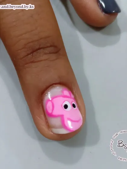 A close-up of George Pig, hand-painted with precision on a short nail.
