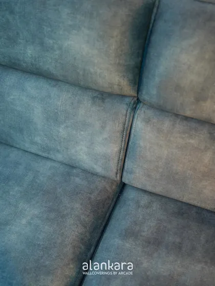 A macro shot of the luxe blue fabric, revealing its soft texture and subtle color variations that add depth and character to the sofa.