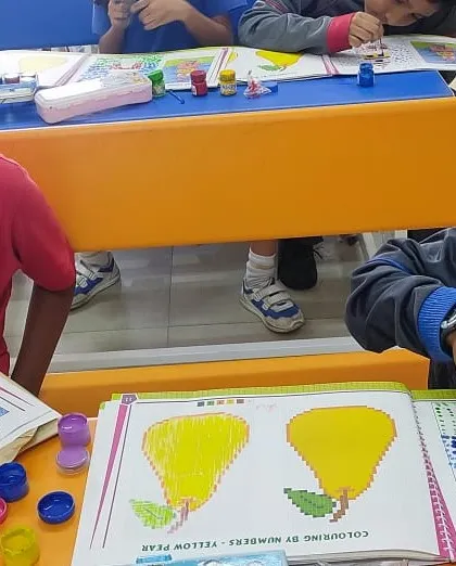 Young students enjoy a finger-painting session, exploring colors and textures in our art class. We believe in nurturing creativity through hands-on artistic exploration.
