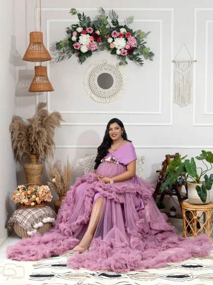 A full view of the boho setup with a beautiful mama-to-be in a lavender ruffled gown. The combination of colors and textures is simply dreamy.