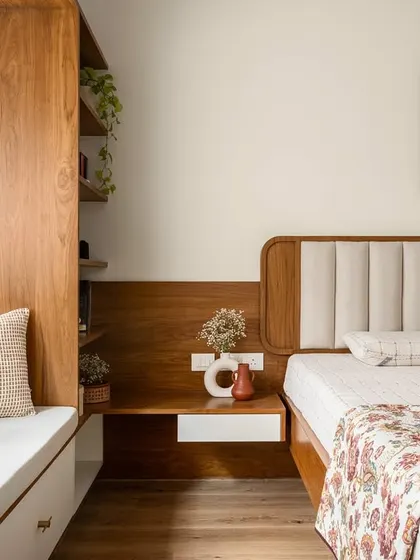 Another view of the 'Palaash' master bedroom, showing the seamless integration of the bed, headboard, and bay window seating. The floral patterns and soft colors create a cohesive and restful space.