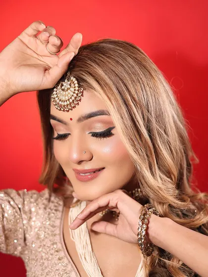 Eyes down, showing the subtle and clean eyeshadow work. The focus is on creating a polished look that isn't overpowering for a day event.