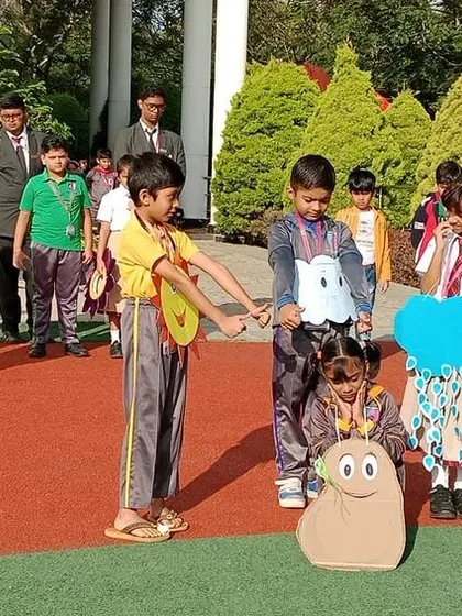 The skit continues, with students acting out the process of a seed growing with the help of sunlight and water.