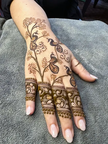 A full view of the artistic peacock tree design. The pattern flows beautifully from the wrist to the fingers.