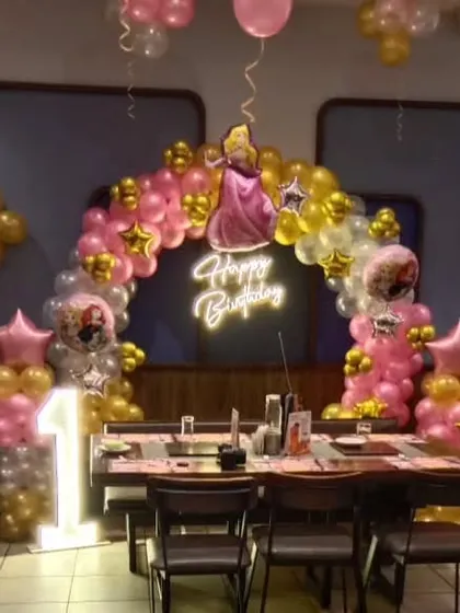 The full view of the princess party table setup, including the backdrop and a light-up number '1'.