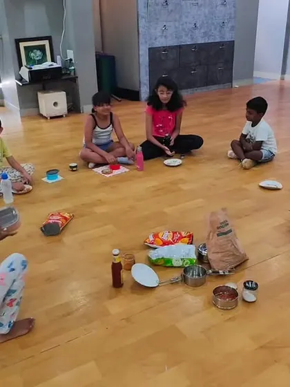 It's not just about dance steps; it's about making things together. Here, the kids are enjoying a simple cooking and craft session during the summer camp.