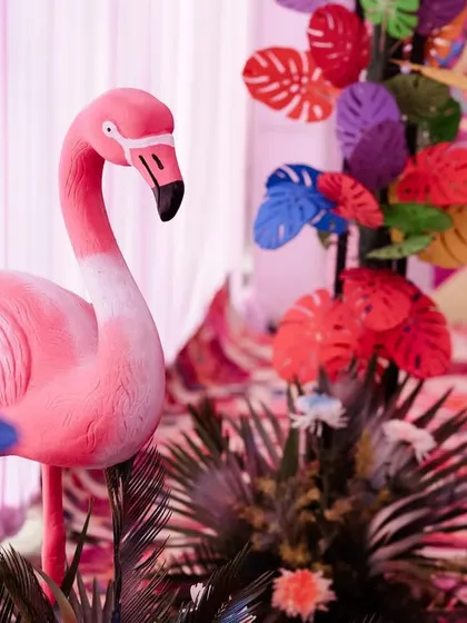A pink flamingo statue, part of a tropical-themed Mehendi decor. It's the small, quirky details that make an event memorable.