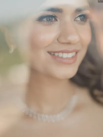 A beautiful, artistic shot capturing her radiant smile. The dewy skin and soft eye makeup create a truly angelic look.