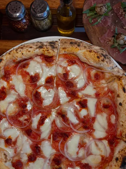 Pizza so good, it just might be your new love language. This is our Goan Sausage pizza.