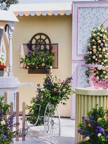 A detailed shot of the flower bar and vintage bicycle, overflowing with beautiful blooms. These charming details contribute to the overall rustic and whimsical fairytale aesthetic.