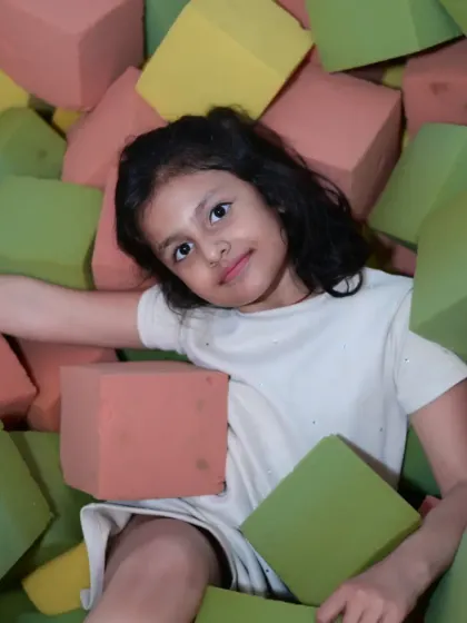 Another angle of our foam pit, showing kids enjoying the soft, colorful blocks. It's a fantastic area for developing coordination and strength.