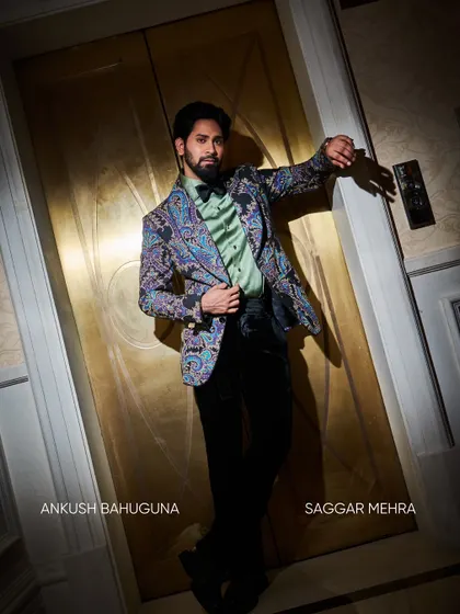 Styled with a bow tie and a mint green shirt, the printed jacket takes on a more formal, eclectic feel. It demonstrates how a single statement piece can be adapted for different occasions.