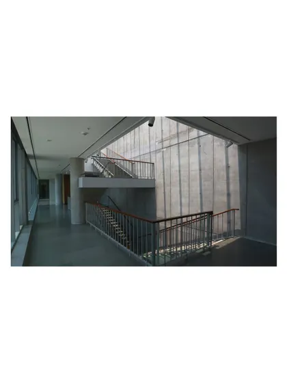 A simple, functional staircase running alongside a translucent wall that filters daylight. In this context, the staircase recedes into the background, demonstrating the duality between utility and expression in our design approach.