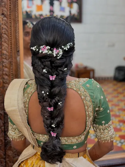 A clear, detailed shot of the butterfly braid, showing the placement of each accessory to create a balanced and enchanting hairstyle.