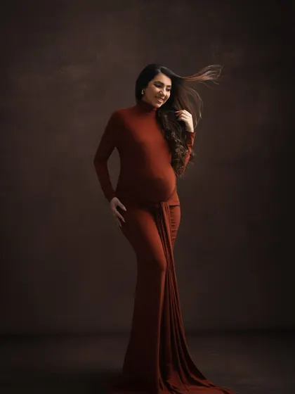 The wind in her hair adds a touch of dynamic energy to this beautiful solo portrait, showcasing the flowing fabric of the earthy-toned gown.