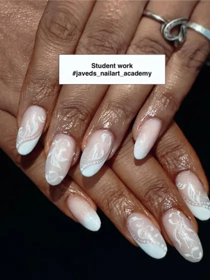 Here is a beautiful example of our student's work. This elegant design features a soft baby boomer or French ombré effect, overlaid with delicate white hand-painted swirls for a sophisticated finish.