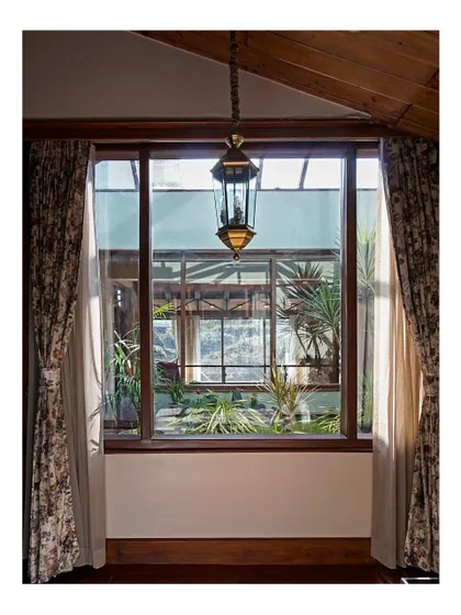 Looking through the bedroom window reveals layers of space, from the interior to the courtyard and beyond. This intentional layering is a technique I use to create visual depth and reinforce the home's connection to its surroundings.