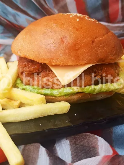 The complete Chicken Zinger Burger meal. The combination of the crispy burger and salty fries is a guaranteed crowd-pleaser for any event.