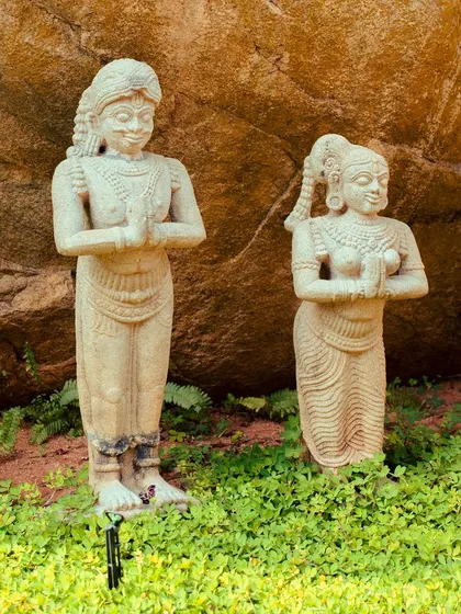 Stone statues in a prayer pose add to the tranquil and spiritual ambiance of our gardens.