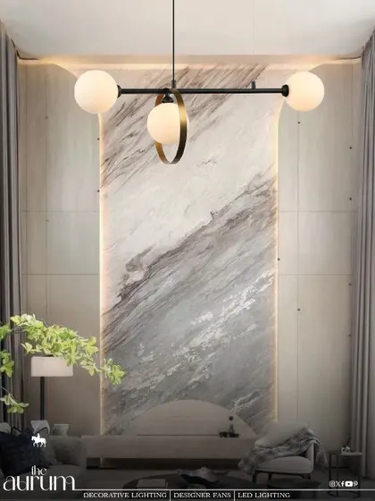 A minimalist masterpiece, this linear pendant features three globe lights, one of which is accented with a brass ring. It's a sculptural piece that doubles as art, perfect for highlighting an architectural feature wall.