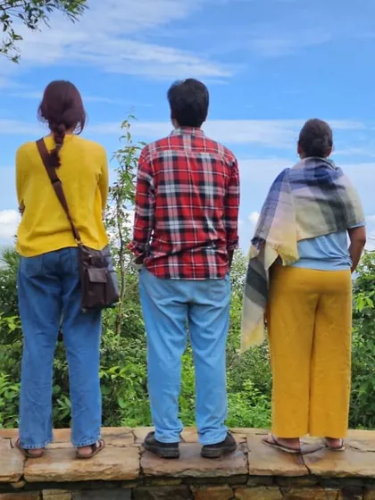 A group of participants taking a moment to admire the valley view together. Shared silence is as much a part of the community experience as shared stories.
