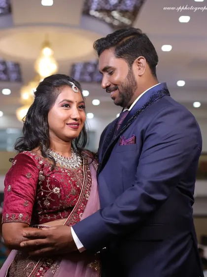A classic reception portrait in a grand hall. We capture the couple's elegant attire and the sophisticated ambiance of the event.