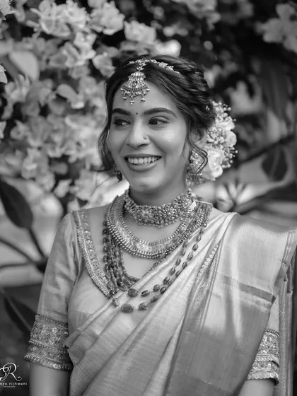 A black and white version of the bride's smiling portrait, full of happiness and light.