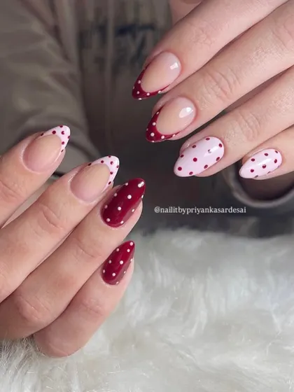 Spotted: the cutest nails in town. A playful mix of red and pink polka dot nails, including some with a French tip design for a modern twist.
