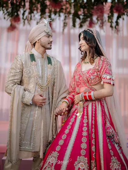 A classic couple portrait after the ceremony, holding hands and looking at each other with love and promise for the future.