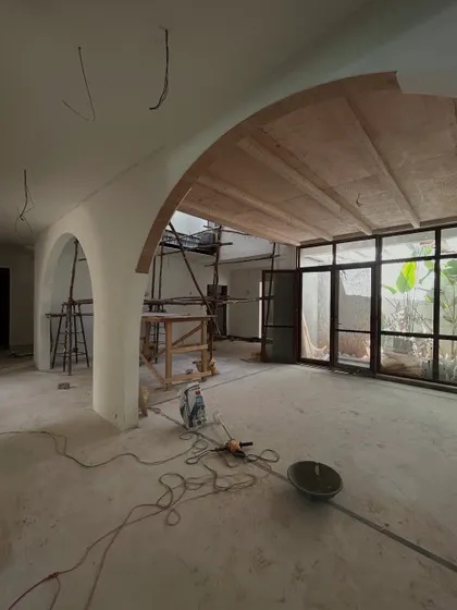 Embracing the chaos of "March madness" on a project site. This is a real look at the construction process, with scaffolding and tools, as we build the foundational elements like arches and ceilings.