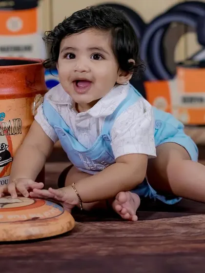 The happy face of a little mechanic in our garage-themed shoot. The interactive set makes for genuine smiles.