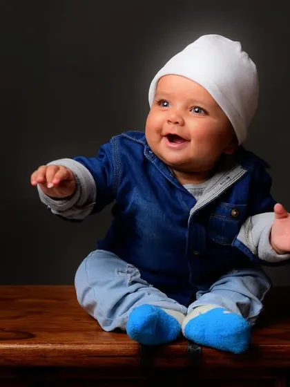 An adorable baby portrait showing a big, happy smile. My goal is to capture these fleeting expressions during our kids' photoshoots.
