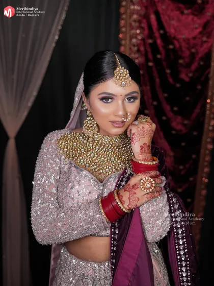 A direct portrait that shows how a clean, classic bridal bun frames the face and allows the makeup and jewelry to take center stage.