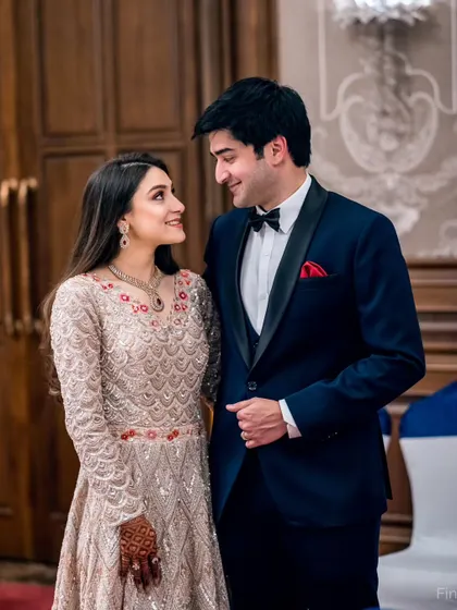 A classic portrait from an evening function. The couple's formal attire and the elegant backdrop create a sophisticated and timeless image.