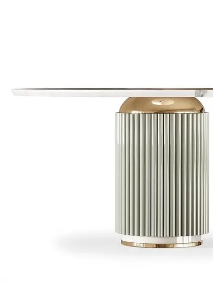 This design features a wood and steel dining table with a fluted pedestal base. The combination of materials and textures makes it a standout piece, suitable for a dinner party or family get-together.