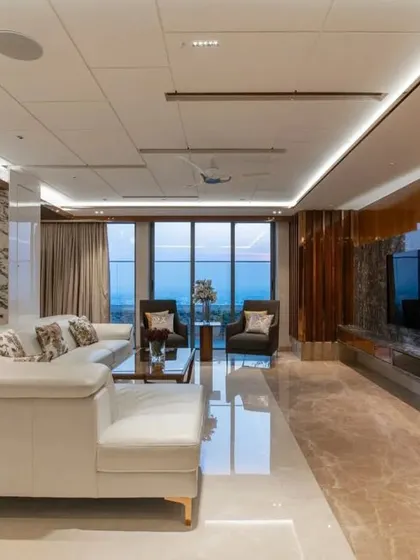 A view of the living area with the city skyline visible through the large windows, demonstrating how we frame views to be a part of the interior design.