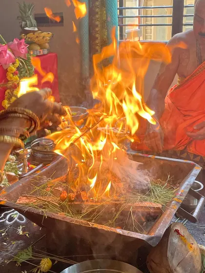 The sacred fire of the yajna. Fire is a powerful purifying element that carries our offerings and prayers to the divine. It represents the fire of knowledge that burns away ignorance.