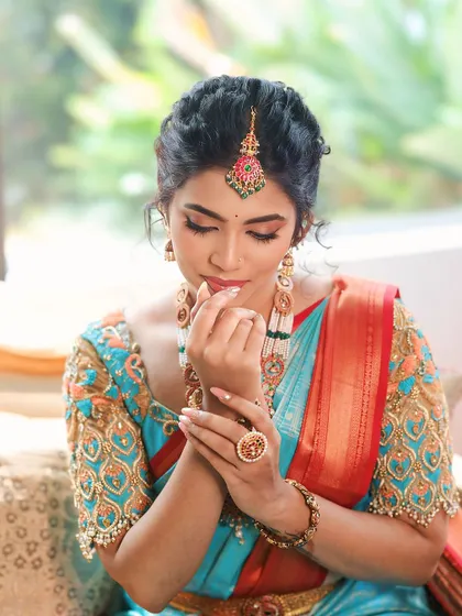 A close-up of the makeup details. The focus is on flawless skin, defined brows, and a touch of color on the lips.
