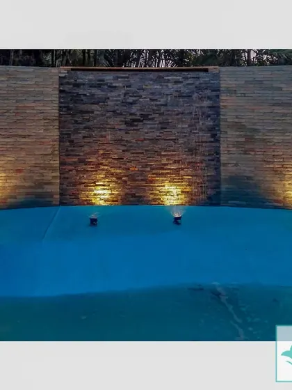 For this poolside area, I designed a stone water wall with integrated lighting. The gentle sound of cascading water and the warm uplighting create a resort-like feeling of luxury and tranquility during the evening.