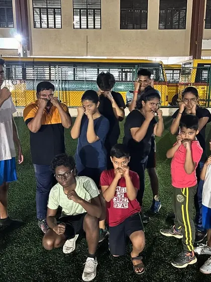 The summer camp crew having some fun while practicing their guard. Our program for kids balances serious training with enjoyable activities to keep them motivated.
